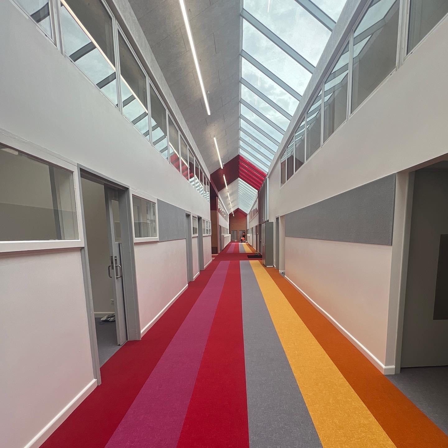 Multi-colour carpet strip installation, school corridor